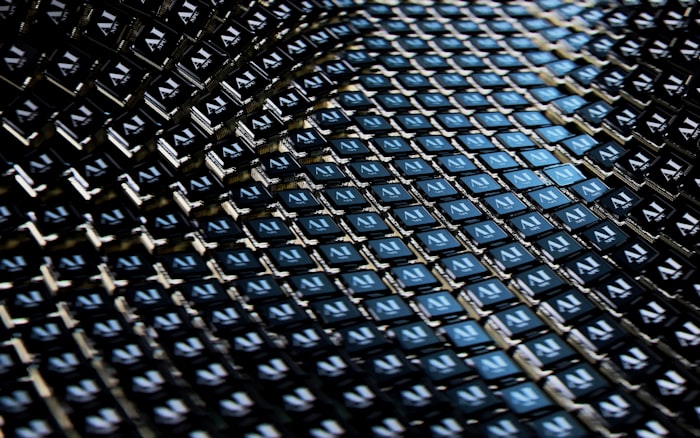 Abstract close-up of AI chip circuitry in dark blue tones representing digital processing